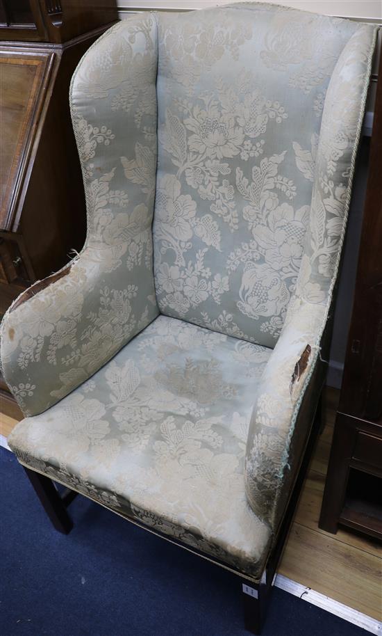 A George III mahogany wing armchair, of slender proportions